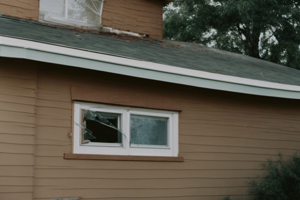 Denver residential home with broken windows, security film visible
